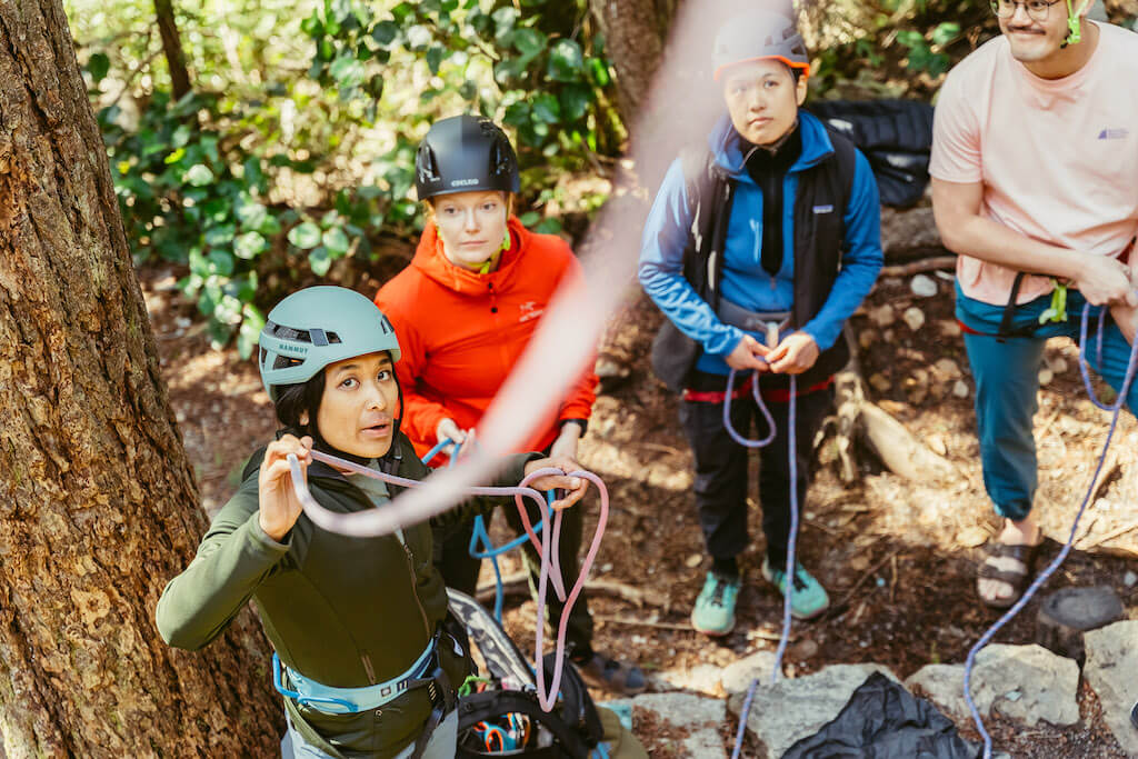 Emma Contaoe teaching people how to climb