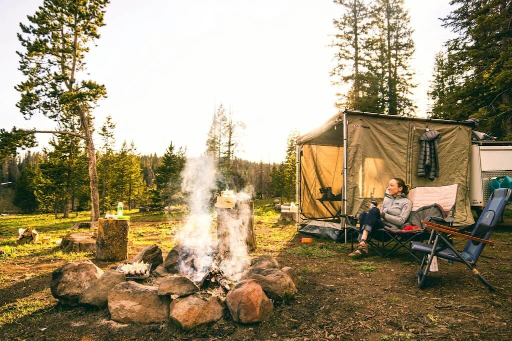 Photo of a camping tent at a campground looking out at the wilderness