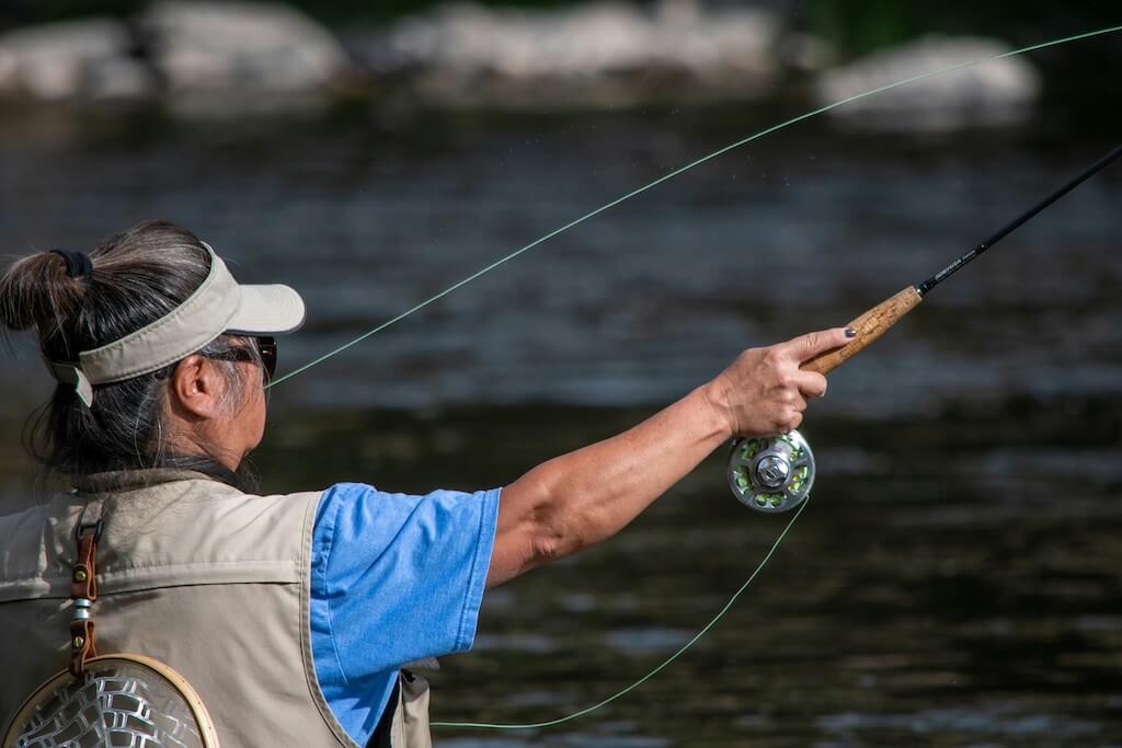 casting a fly fishing rod on a river