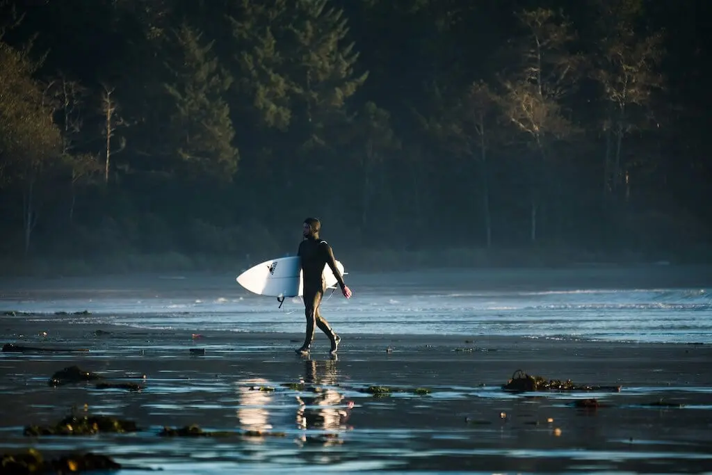 surfer near Tofino walking with board to ocean