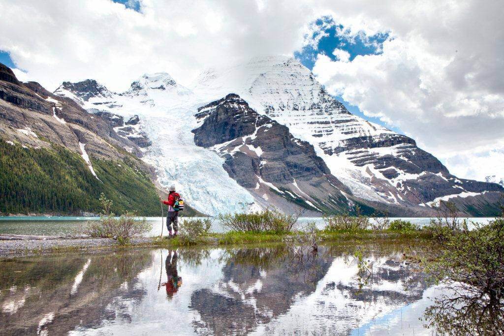 A hiker admiring Mount Robson along the Berg Lake Trail in Mount Robson Provincial park (Thompson Okanagan / Robson Heli Magic)