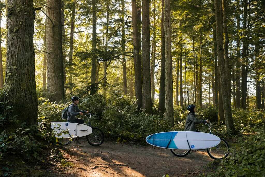 riding through forest to surf in Tofino, BC